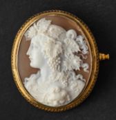 An oval, shell cameo brooch, depicting Dionysus, the god of wine, in profile,