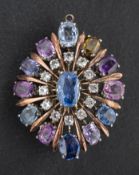 An oval, mixed-cut, vari-coloured sapphire and probably white topaz brooch/ pendant,