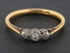 A single and round, brilliant-cut diamond, three-stone ring, total estimated diamond weight ca. 0.