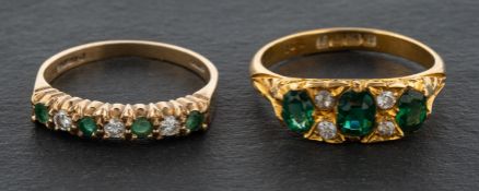 Two gemset rings, including a 9ct gold, emerald and diamond half eternity band and an 18ct gold,