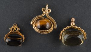 Three swivel fobs, including a 9ct gold, smokey quartz fob; a 9ct gold,