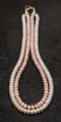 A two-row cultured pearl necklace, the cultured pearls of button form,
