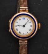 A 9ct gold ladies watch with blue enamelled circle to bezel the dial with black Roman numerals,