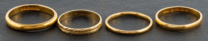 Four gold band rings, including three 22ct gold rings, weight ca. 7.