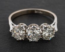 A round, brilliant-cut diamond, three-stone ring, total estimated diamond weight ca. 1.