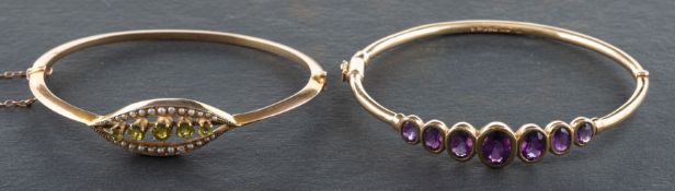 Two gem-set bangles, including a 9ct gold, oval, mixed-cut amethyst, hinged bangle,