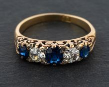 An oval, mixed-cut sapphire and round, old-cut diamond five-stone ring,