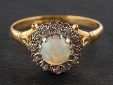 An 18ct gold, round, cabochon-cut opal and single-cut diamond cluster ring,