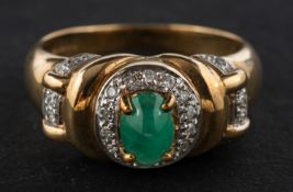 A 9ct gold, oval, cabochon-cut emerald and round, brilliant-cut diamond cluster ring,