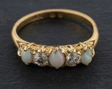 An oval, cabochon-cut opal and old-cut diamond, five-stone ring, total estimated diamond weight ca.
