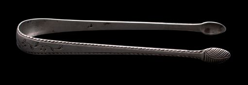 A pair of George III Silver feather edged sugar tongs with engraved foliate decoration,