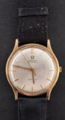 Omega Genève, a gentleman's gold wristwatch the silvered dial with raised gold baton numerals,