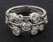 An 18ct gold, round, brilliant-cut diamond, nine-stone ring, total estimated diamond weight ca. 1.