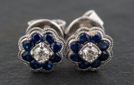 An 18ct gold, pair of round, mixed-cut sapphire and round, brilliant-cut diamond cluster ear studs,
