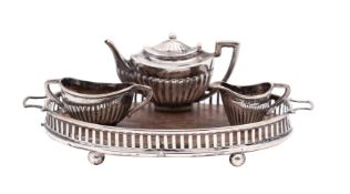 An Edward VII silver miniature three-piece tea service on an oval galleried twin-handled tray,
