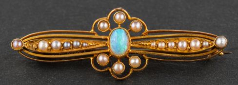 An early 20th century, oval, cabochon-cut opal and seed pearl openwork brooch,