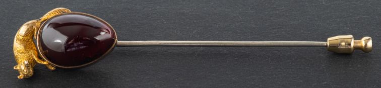 A pear-shaped, cabochon-cut garnet tie pin, surmounted by a fox, total length ca. 8.
