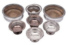 A pair of silver plated circular wine coasters with gadrooned rims and turned wood bases, 15.