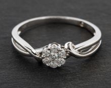 A round, brilliant-cut diamond, flowerhead cluster ring, total estimated diamond weight ca. 0.