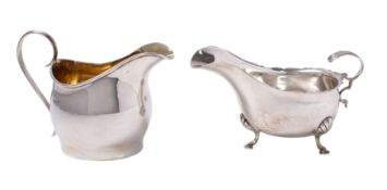 A George V silver cream jug, Birmingham 1910 of plain helmet shape with scroll handle, 10cm high,