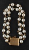 A double-rowed cultured pearl bracelet, the cultured pearls varying in hue from cream to light grey,