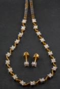 A bi-colour, fancy-link, round, brilliant-cut diamond necklace and earstuds, of flowerhead design,