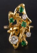 A 1960's round, brilliant-cut diamond and emerald dress ring, total estimated diamond weight ca. 0.