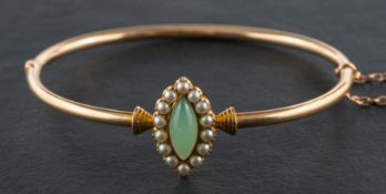 A navette-shaped, cabochon-cut chalcedony and seed pearl cluster hinged bangle, inner diameter ca.