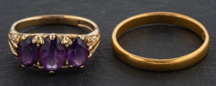 A 9ct gold, oval, mixed-cut amethyst three-stone ring, length of ring head ca. 1.