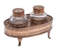 A late 18th Century silver plated ink stand of oval outline with galleried sides,
