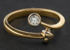 A round, brilliant-cut diamond and heart-shaped decoration, cross-over ring,