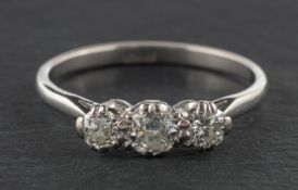 A round, brilliant-cut diamond, three-stone ring, total estimated diamond weight ca. 0.