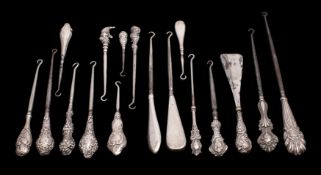 A collection of sixteen silver handled button hooks with plain, engine turned and embossed handles,