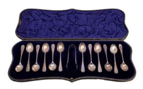A set of twelve George V silver Old English teaspoons and a pair of matching sugar tongs,