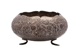 An Indian silver circular sugar basin embossed with flowerheads and scrolling foliage,