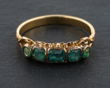 A green paste five-stone ring, length of ring head ca. 1.6cm, ring size M, total weight ca. 2.2gms.