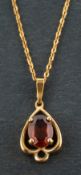 An oval, mixed-cut citrine pendant, estimated citrine weight ca. 0.