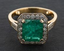 An 18ct gold, emerald-cut emerald and round, brilliant-cut diamond cluster ring,