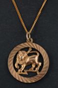 A 9ct gold, pendant depicting a lion, representing the astrological sign of Leo,