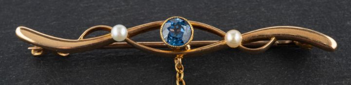 An Art Nouveau, seed pearl and probably synthetic sapphire, openwork brooch, stamped '15CT',
