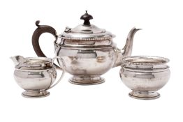 A George V silver three-piece pedestal tea service, makers Mappin & Webb,