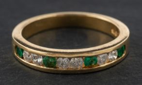 A round, mixed-cut emerald and round, brilliant-cut diamond half-eternity ring,