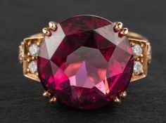 An 18ct gold, round, faceted rhodolite garnet and round, brilliant-cut diamond ring,