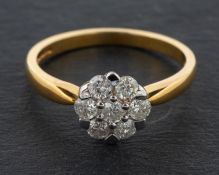 A round, brilliant-cut diamond cluster ring, total diamond weight ca. 0.