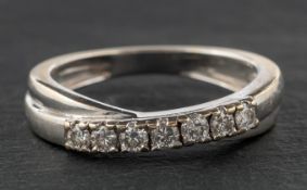 An 18ct gold, round, brilliant-cut diamond, cross-over, half-eternity ring, diamond weight 0.
