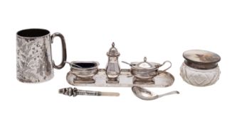 An assortment of silver items to include: a silver lidded glass bodied dressing table jar with hand