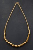An 18ct gold, graduated bead necklace, diameter of beads ca. 2.5-9.
