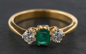An 18ct gold, emerald and diamond, three-stone ring, estimated emerald weight ca. 0.