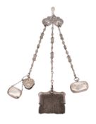 A chatelaine with white metal clasp decorated with figures and scrolling foliage,