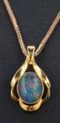 An oval, cabochon-cut opal doublet pendant, stamped 'SIL', length ca. 2.